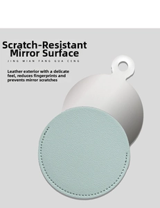 Close-up of light blue litchi pattern leather sleeve and portable metal mirror detail