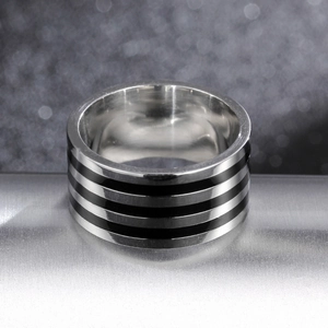Polished 10mm 316L stainless steel ring with black enamel stripes on metal stand