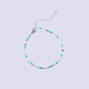 Detail of silver chain bracelet with green enamel beads and adjustable lobster clasp