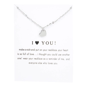 Close-up of a silver heart pendant necklace on a romantic I LOVE YOU gift message card