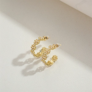 Elegant gold-tone C-shaped hoop earrings with pearls and hollow flower details
