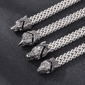 Detailed view of Viking style steel chains with eagle, wolf and snake heads and silver finish