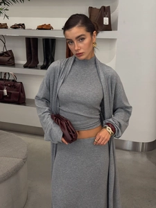 Three-piece gray knit set with turtleneck, long cardigan, and skirt on a model