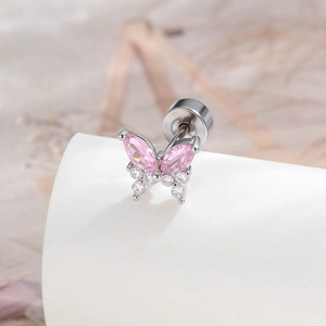 Silver butterfly cartilage earring with pink and clear zircon crystals on white stand