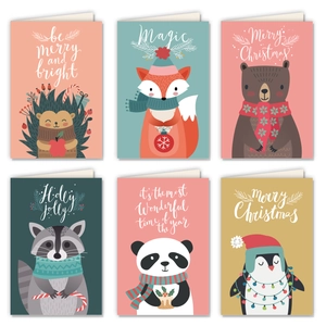 Flat lay of six cute animal-themed Christmas cards with colorful holiday illustrations