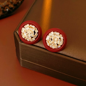 Close-up of vintage red oval earrings with gold-plated zircon inlay in a jewelry box