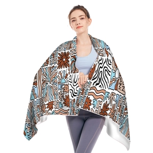 Detail view of microfiber beach towel with sunshine print and multi-color abstract patterns