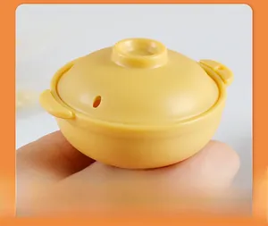 Macro shot of miniature yellow ABS clay pot model with vent hole detail on lid