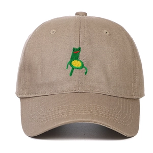 Detailed close-up of cartoon frog embroidery on khaki cotton baseball cap crown