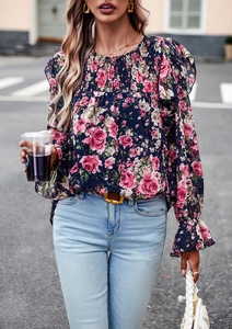 Detail of smocked high neck and ruffled cuffs on dark blue rose floral print blouse