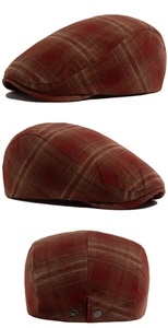 Detail view showing red plaid texture and adjustable metal snaps on the vintage flat cap