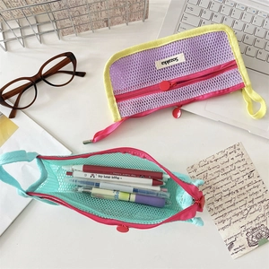 Close-up of semi-transparent mesh pencil cases with dual zippers and colorful contrast edges