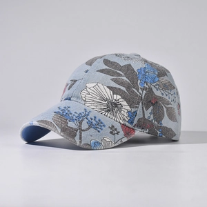 Close-up of denim baseball cap with blue and white floral pattern and premium stitching