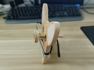 Detail of wooden animal glasses holder with natural wood grain and cartoon paint finish