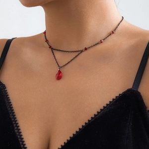 Close-up of gothic double-layer necklace featuring red crystal drop and black metal chain