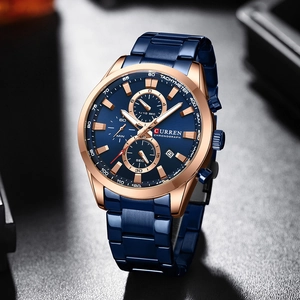 Close-up of chronograph watch featuring blue dial, tachymeter bezel and date window