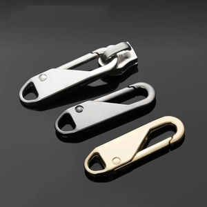 Universal metal zipper pullers in silver, gold, and gunmetal on a reflective surface