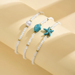 Close-up of bohemian anklet set with white seed beads, turquoise and starfish charms