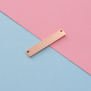 Detailed view of rose gold rectangular stainless steel connector with dual holes for DIY jewelry