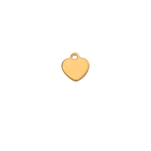 Macro detail of polished gold heart-shaped stainless steel pendant with mirror finish