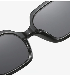 Detailed macro view of the integrated nose pads on black oversized polygonal sunglasses