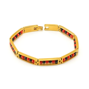 Detail of 18K gold stainless steel bracelet with red and black beads on white background