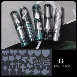 Macro detail of Gothic nail art stencils with bow, heart, and butterfly motifs for long nails