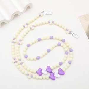 Acrylic beaded phone strap with cream and purple beads featuring hearts and bows