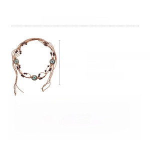 Detailed view of bohemian hemp rope waist chain with wooden beads and floral rhinestone disks