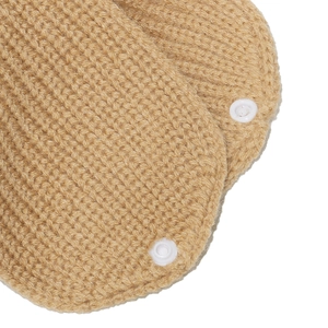 Macro view of khaki ribbed knit fabric with white plastic snap button closure details