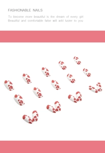 Detail of red cow print short ballet press-on nails with vibrant white base color