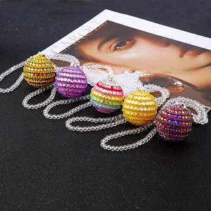 Elegant crystal ball necklaces with colorful beaded chains on a professional black surface