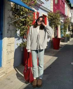Close-up of grey tie-front knit cardigan featuring a soft texture in a street style setting