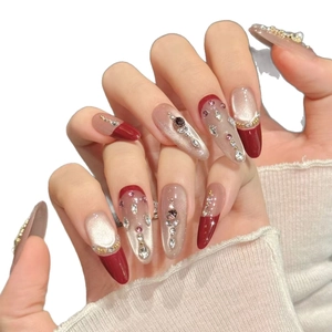 Faux ongles amande rouge foncé avec effet œil de chat argenté et accents de pierres précieuses