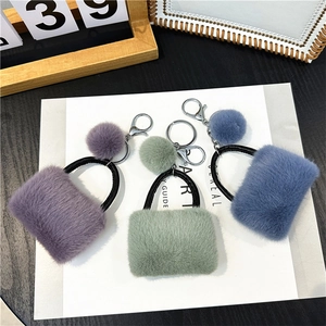 Plush mini bag keychains in purple green and blue with soft pompom and metal clip