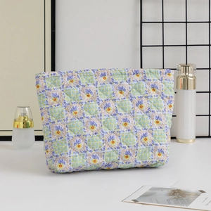 Quilted floral toiletry bag shown in a lifestyle setting with cosmetic accessories