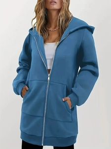 Detail view of the blue oversized zip-up hoodie featuring large pockets and loose fit