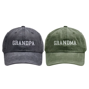 Detail of washed cotton baseball caps in dark grey and olive with Grandma Grandpa embroidery