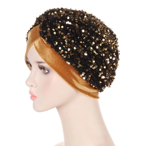 Fashionable black velvet turban cap with shimmering gold sequins and elegant dual-tone design