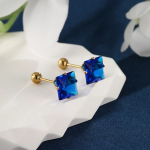 Macro detail of square blue gemstone earrings with gold-plated screw ball backings