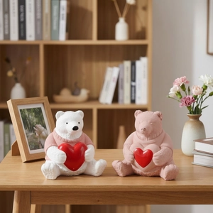 Macro detail of sitting bear resin molds with heart and knitted sweater texture