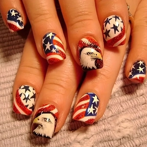 Close-up of USA flag nails featuring red stripes, blue stars and bald eagle design
