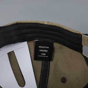Macro detail of 100% cotton wash label and inner sweatband on khaki baseball cap