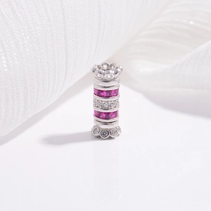Macro detail of S925 silver cylinder bead with pink gemstones and white zircon accents