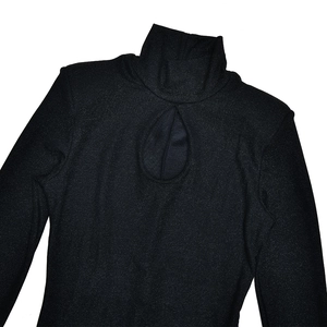 Detail of elegant black turtleneck dress with teardrop cutout and shimmering fabric texture