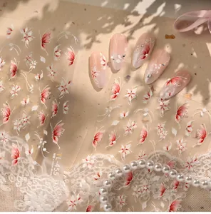 Close-up of TL-455 floral butterfly nail stickers on soft pink nails with pearl accents