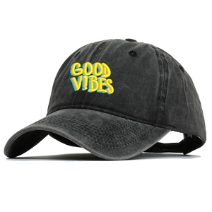 Detailed view of Good Vibes colorful embroidery on washed charcoal denim baseball cap