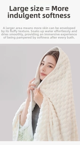Close-up of beige bath towel with textured wave pattern and soft absorbent coral fleece