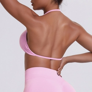 Detailed back view of pink halter sports bra and high waist leggings for yoga