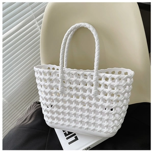 Detailed woven texture of a white hollow-out jelly basket bag on a chair